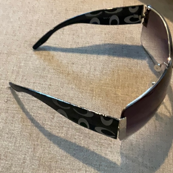 Coach logo sunglasses with gold detail.